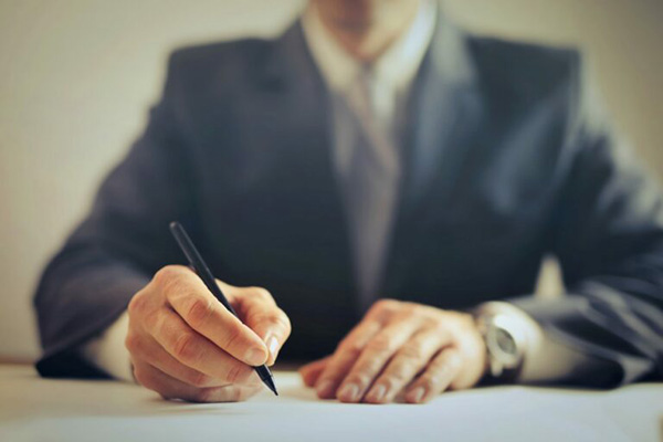 Lawyer signing paperwork