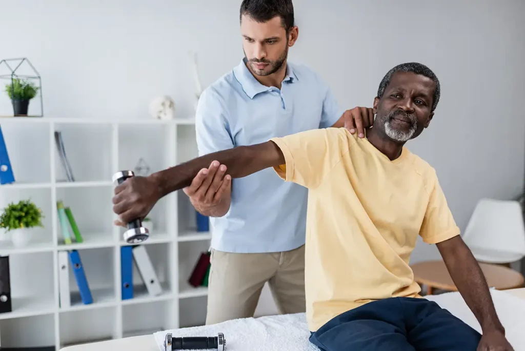 car accident doctor working on a patient's shoulder