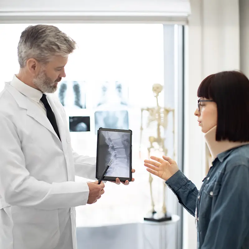 injury doctor consulting with patient about neck injury