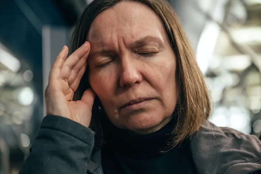 Car accident victim experiencing concussion symptoms including headache and dizziness