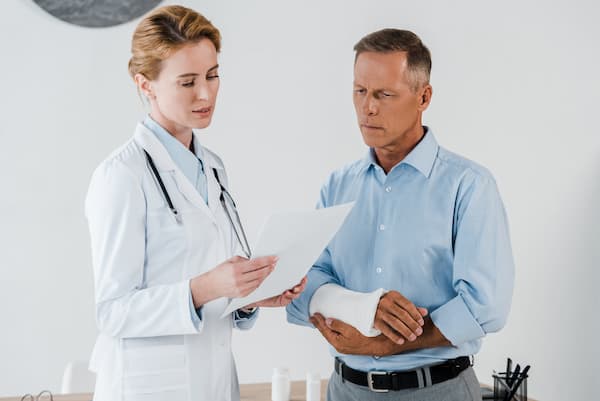 doctor and patient with broken arm