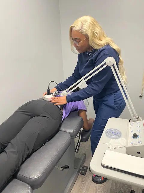 Chiropractor examining a patient's lower back pain