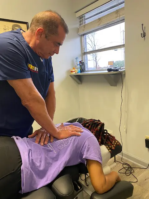 Chiropractor adjusting a patient's spine