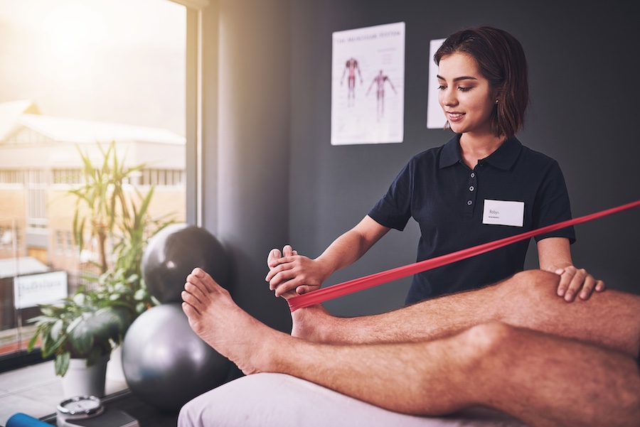 A physical therapist is performing a functional capacity evaluation on a patient.