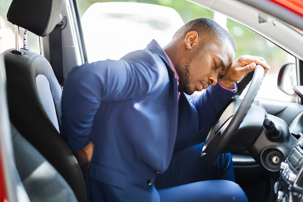 A Driver suffers back pain after a car accident.